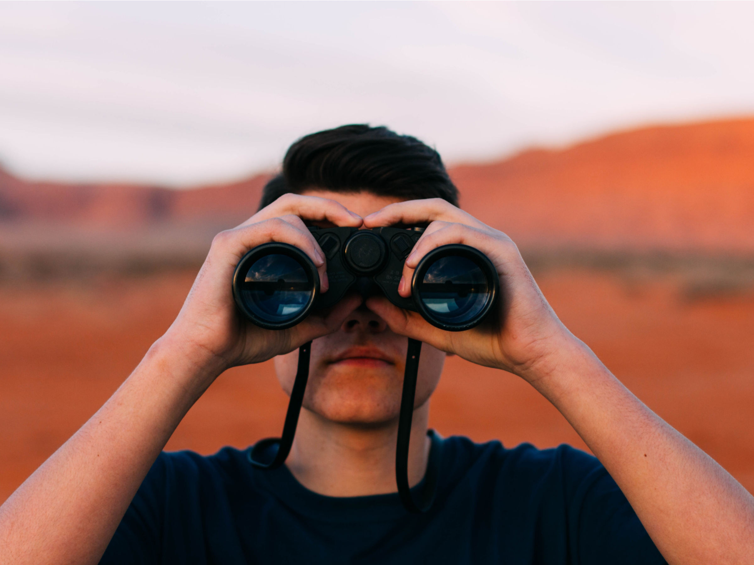 Man searching with binoculars