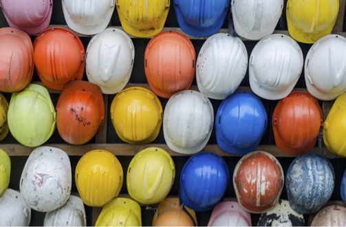 A collection of different coloured hard hats